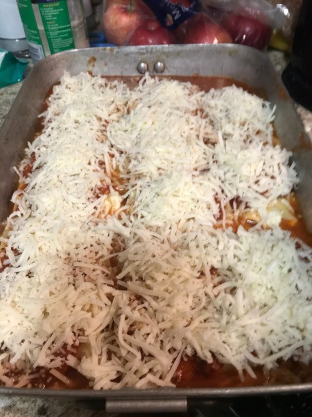 cheese on Lasagna Roll Ups in pan
