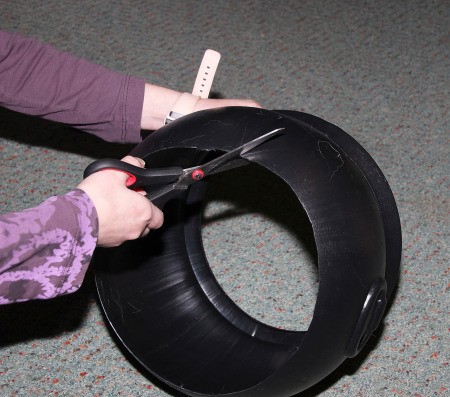 Witch Doctor and Shrunken Head Costumes - cutting the bottom out of a plastic cauldron