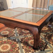 Value of an Opium Leg Coffee Table - table with four glass inserts and distinctive curved legs