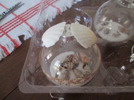 Coastal Beach Ornaments - ornaments sitting in the plastic try after decorating, one has larger shells attached on the top