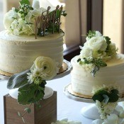 Adding Fresh Flowers to Cake Decoration - two small wedding cakes decorated with fresh flowers