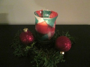 DIY Stained Glass Candle Holder - finished candle holder with candle lit, dark image