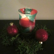 DIY Stained Glass Candle Holder - finished candle holder with candle lit, dark image