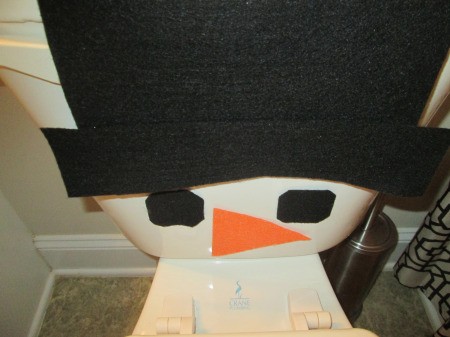 Winter Wonder Bathroom - hat, eyes, and nose attached to the tank