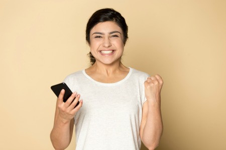 A happy woman with her phone.