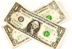 Two U.S. Dollar bills on a white background.