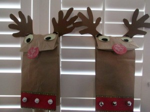 Reindeer Puppets - puppets against wooden blinds