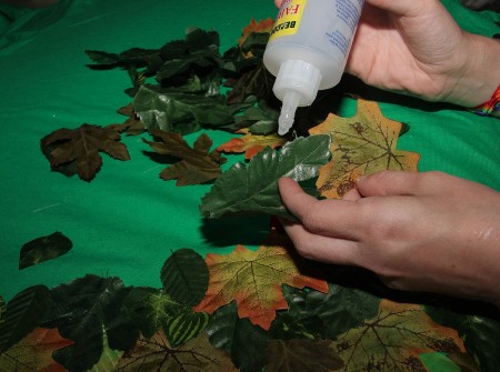 Glueing leaves on the outfit.