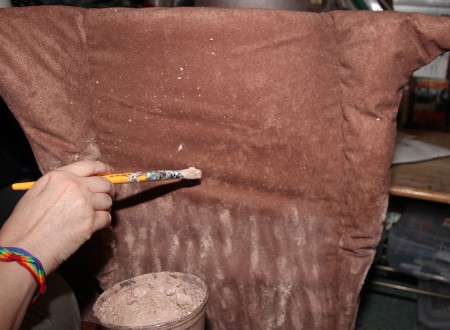 Painting the tree trunk costume.