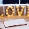 Wedding guest book with letter lights spelling LOVE.