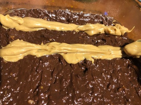 Peanut Butter stripes on top of brownie batter