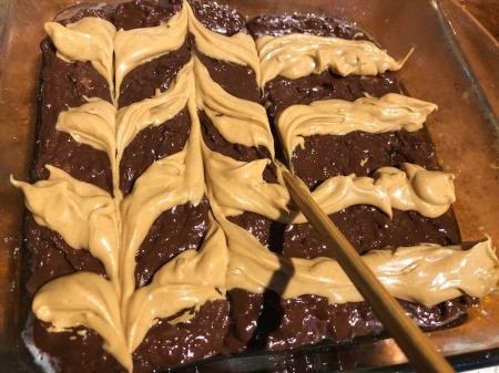 pulling knife through the stripes of peanut butter