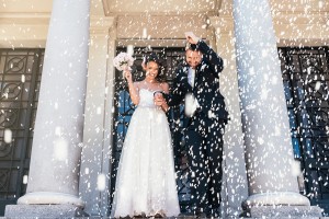 Bride and groom running from the church