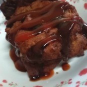 leftover fish patties drizzled with sauce on plate