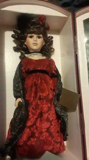 Value of a Collectors Choice Porcelain Doll - doll wearing a long red dress and a black shawl