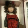 Value of a Collectors Choice Porcelain Doll - doll wearing a long red dress and a black shawl