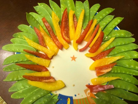 Thanksgiving Turkey Veggie Tray - lay the pepper slices out in alternating colors on top of the peas, in a smaller circle