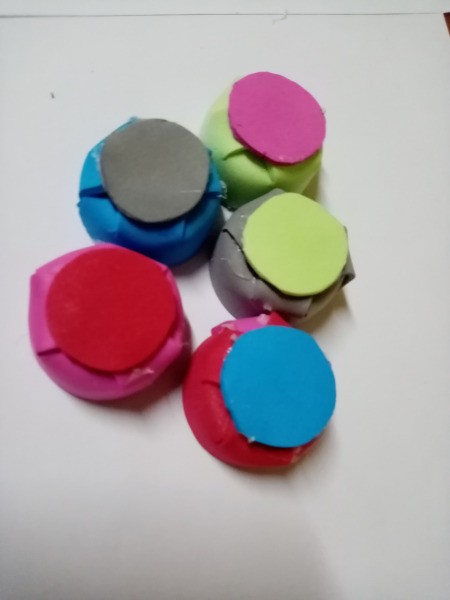 Rubber Foam Stamps on Bottle Caps - circles glued to the top of several caps