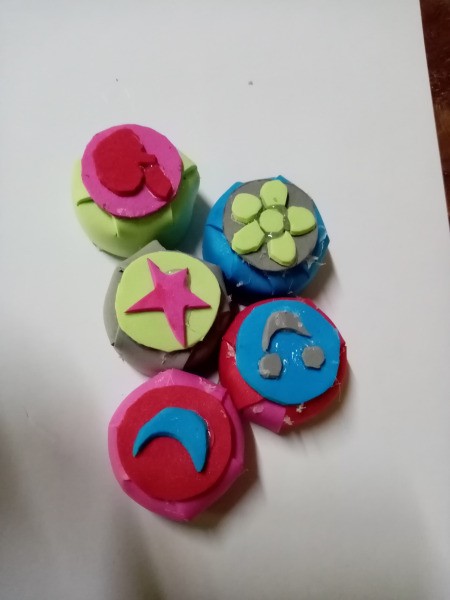 Rubber Foam Stamps on Bottle Caps - foam cutouts glued to the top of the cap