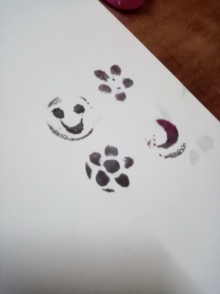 Rubber Foam Stamps on Bottle Caps - example of finished stamped images on a piece of white paper