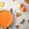 Pumpkin pie with fall leaves and gords.