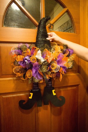 A decorated witch hat on a door.