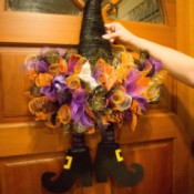 A decorated witch hat on a door.