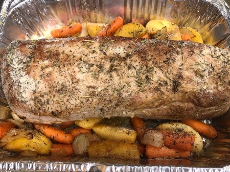 adding veggies to Pork Loin baking dish