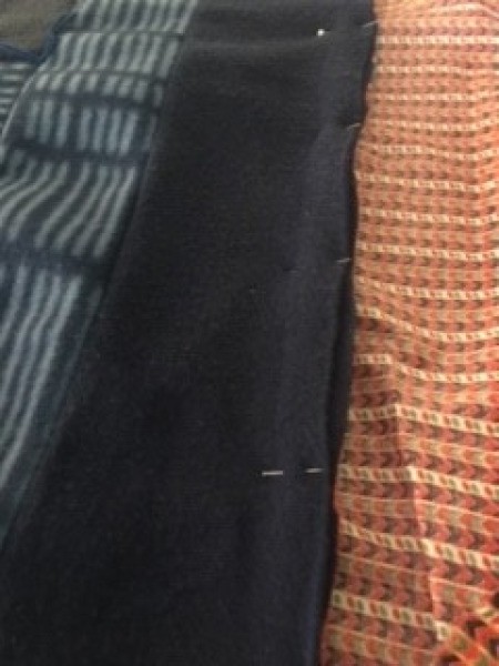 Scrap Quilt for a Baby Boy - cotton strip binding pinned in place, sew