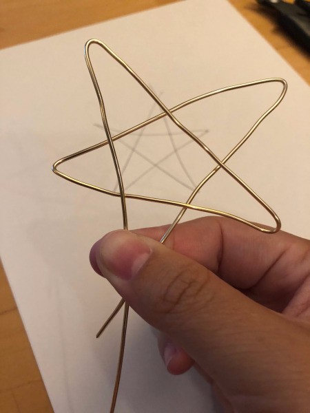 DIY Wire Star Christmas Tree Topper - holding the star shape with one short and one longer end