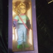 Value of a Collector's Choice Porcelain Doll - doll in original box, wearing a t-shirt with "Smile" on it