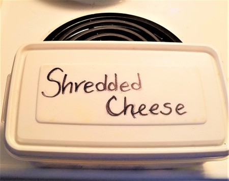 A container holding shredded cheese.