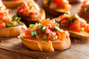 Small slices of bread topped with a tomato mixture.