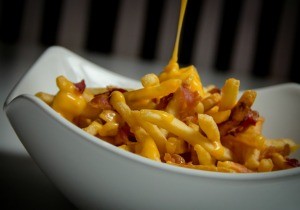 French fries covered with cheese and other toppings.