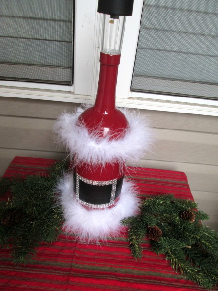 Santa Vase And Lamp - Santa lamp outside on a small table covered with a festive cloth and added greenery