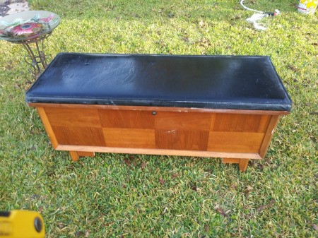 Value of a Lane Sweetheart Cedar Chest - chest with black upholstered top and 8 veneer panels on the front