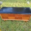 Value of a Lane Sweetheart Cedar Chest - chest with black upholstered top and 8 veneer panels on the front