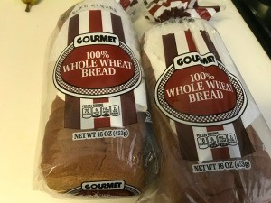 Loaves of bread with paper towels inside the bags.