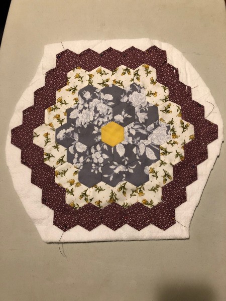English Paper Pieced Flower Pillow - flower atop a piece of Warm and Natural batting, pinned in place