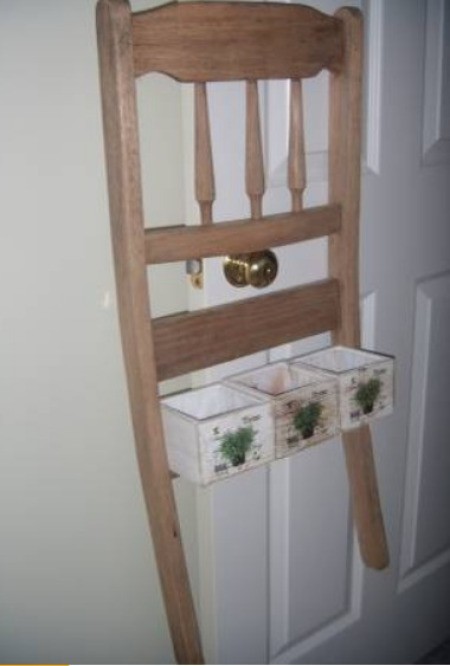 A chair back used as a planter hanger.