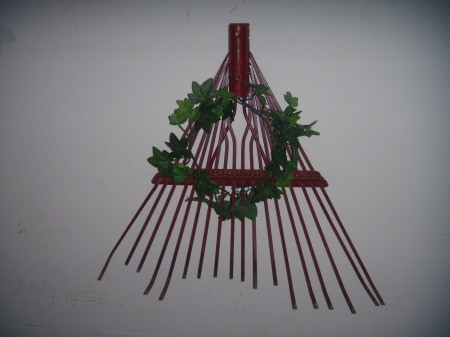 A rake head with a decorative wreath.