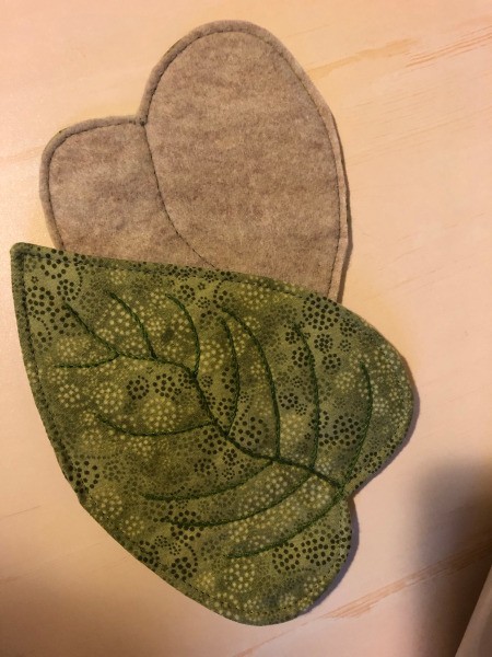 English Paper Pieced Flower Pillow - view of a leaf front with embroidery stitching and back with felt machine stitched in place