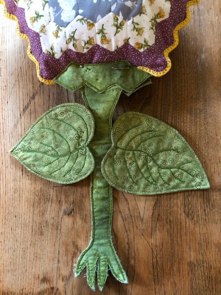 English Paper Pieced Flower Pillow - the leaves were attached with colonial knots at several spots, the stem and leaf assembly is pinned to the flower