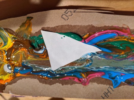 Christmas Tree Banner - tree lying face down on top of the swirled paint