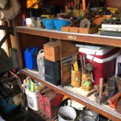 Tools organized on a shelf with recycled cans.