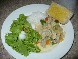 Chicken Curry With Fresh Coconut Milk and salad and rice on plate