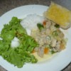 Chicken Curry With Fresh Coconut Milk and salad and rice on plate