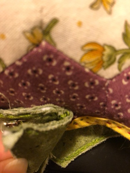 English Paper Pieced Flower Pillow - view of the placement of the stem crown at the base of the flower pillow so that it encompasses part of the pillow itself