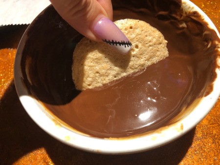 dipping meringue in Chocolate