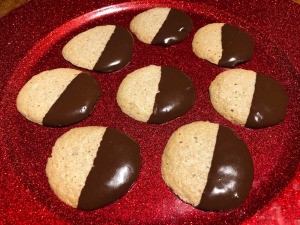 Chocolate Dipped Peanut Butter Meringues on parchment paper